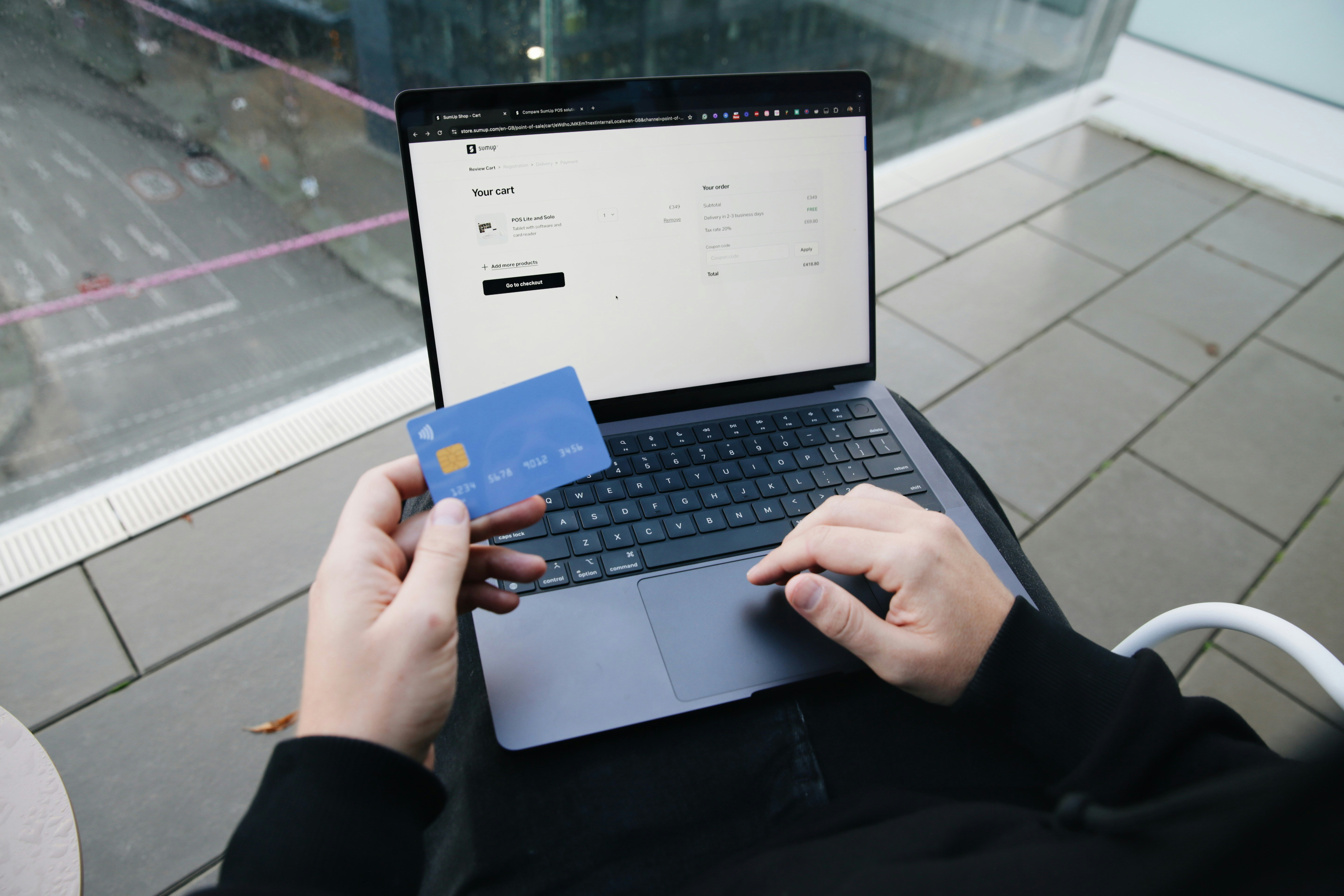 Person with laptop and credit card utilizing an online shopping platform